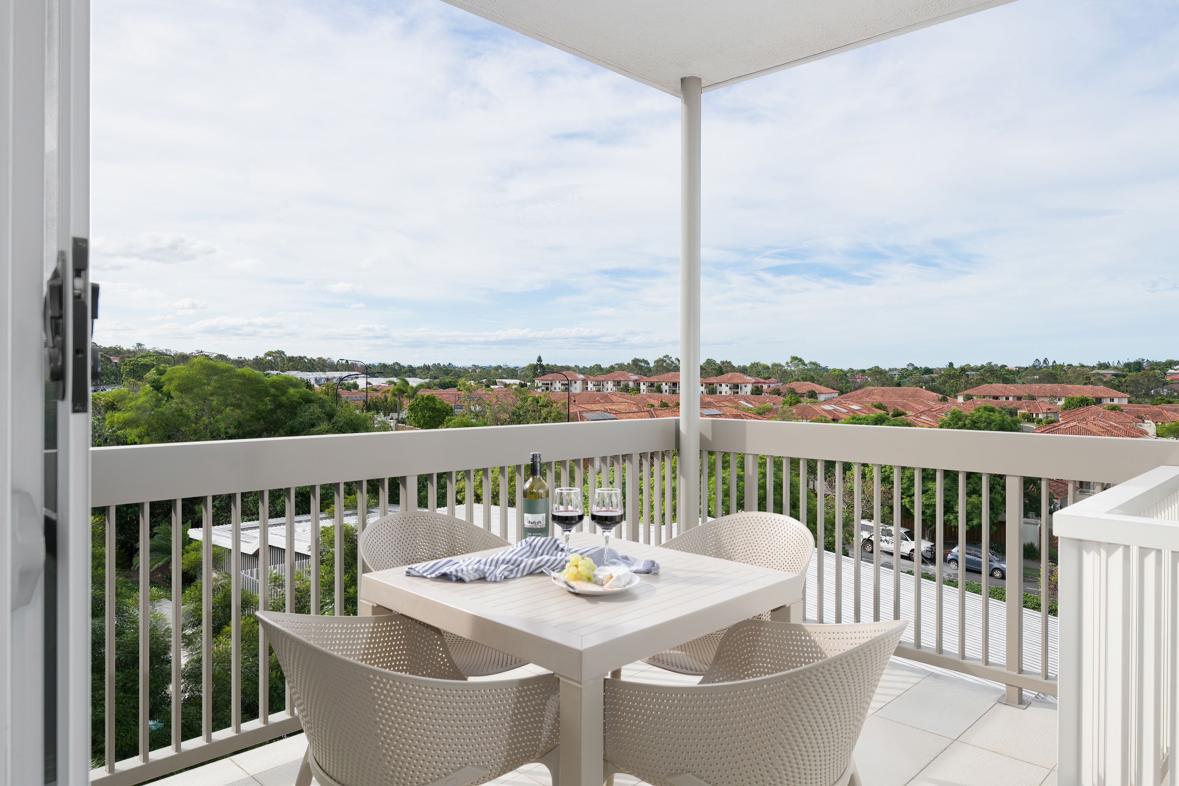 Private balcony with wine and cheese at sunset
