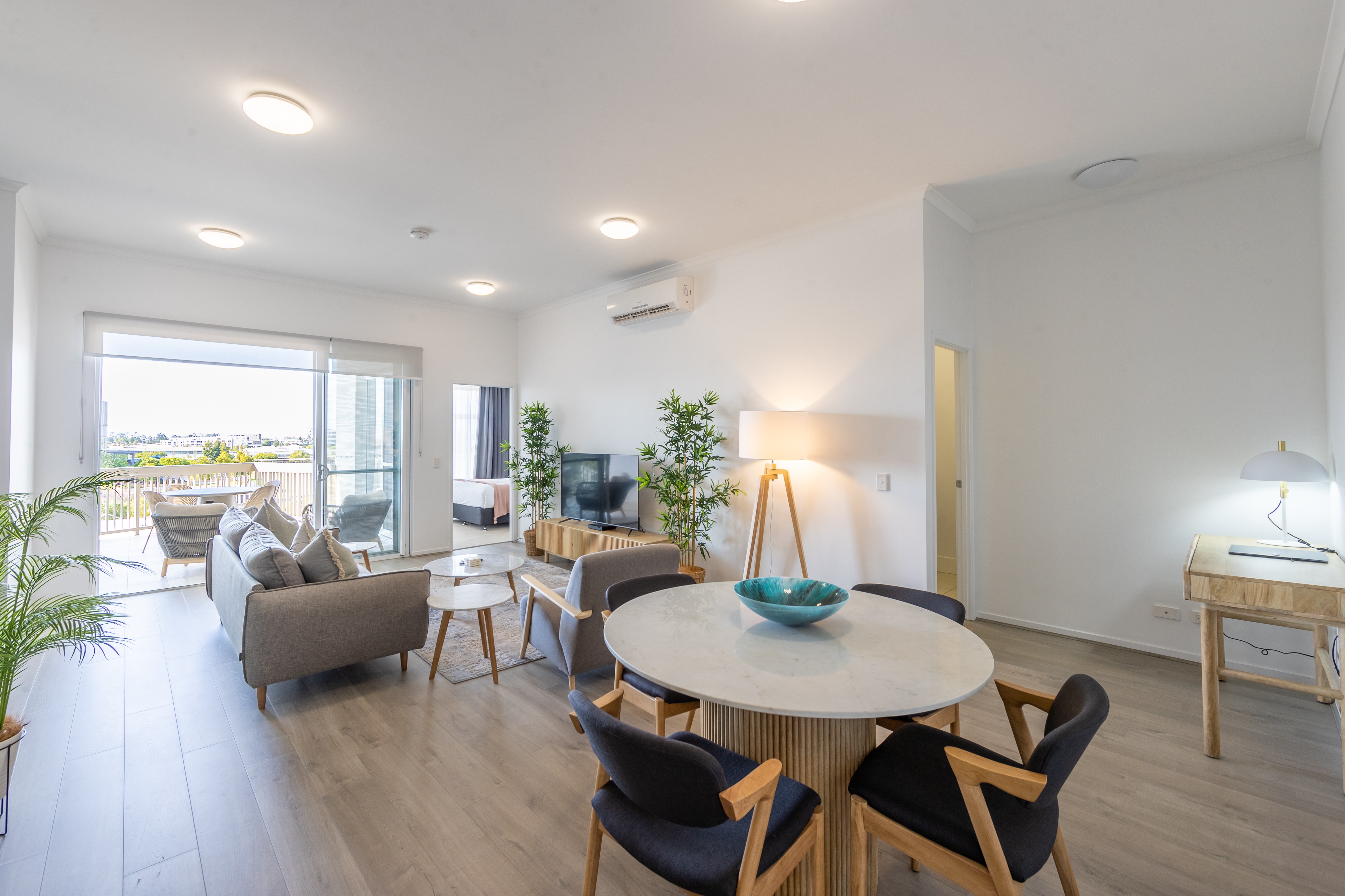 Penthouse open-plan living and dining area with balcony and natural light