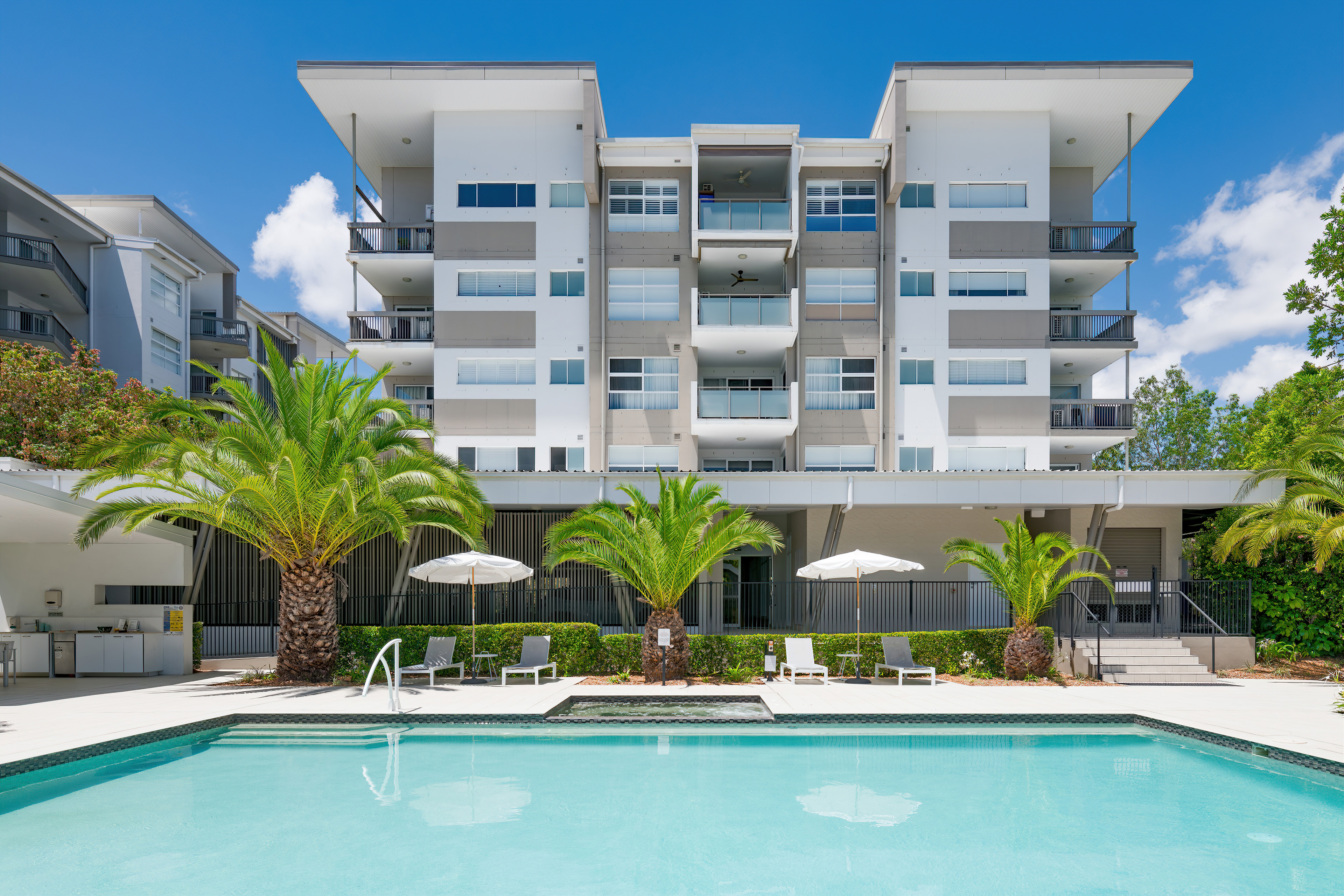 Boulevard North Lakes pool and building exterior at sunset
