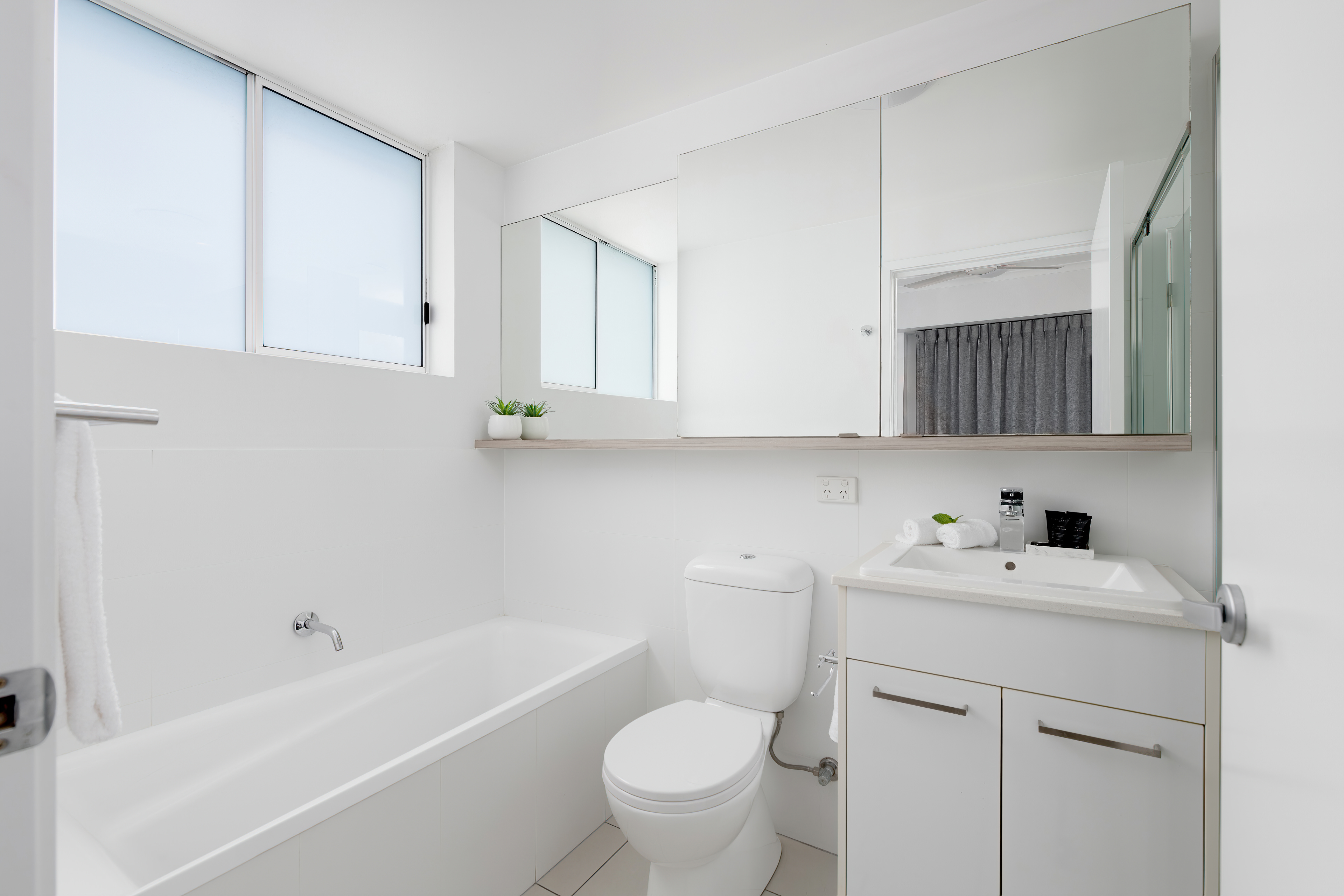 Ensuite bathroom with bath and vanity
